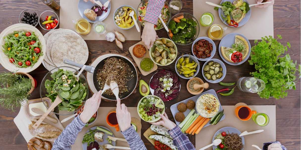 A table laden with vegetarian and vegan dishes.