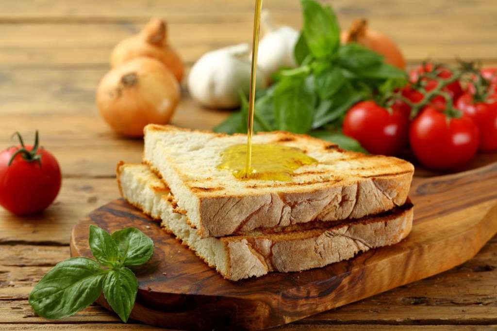 Slices of grilled bread topped with olio nuovo, the first oil of the season produced in Tuscany.
